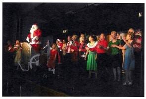 The Spirit of Christmas on Main Street — full cast on stage with Santa sleigh, 2009