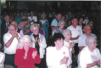 Sing-along with a large crowd at an indoor event